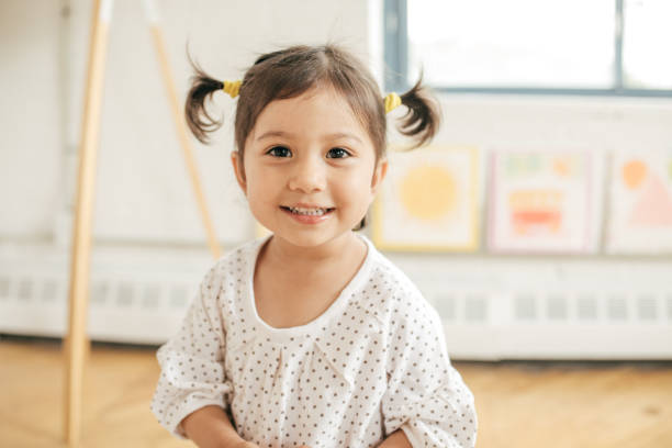 Young girl with pigtails smiling