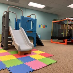 Indoor playground in the NET room at Ally Behavior Centers' Springfield Location with a play structure to enhance our ABA services for autism.